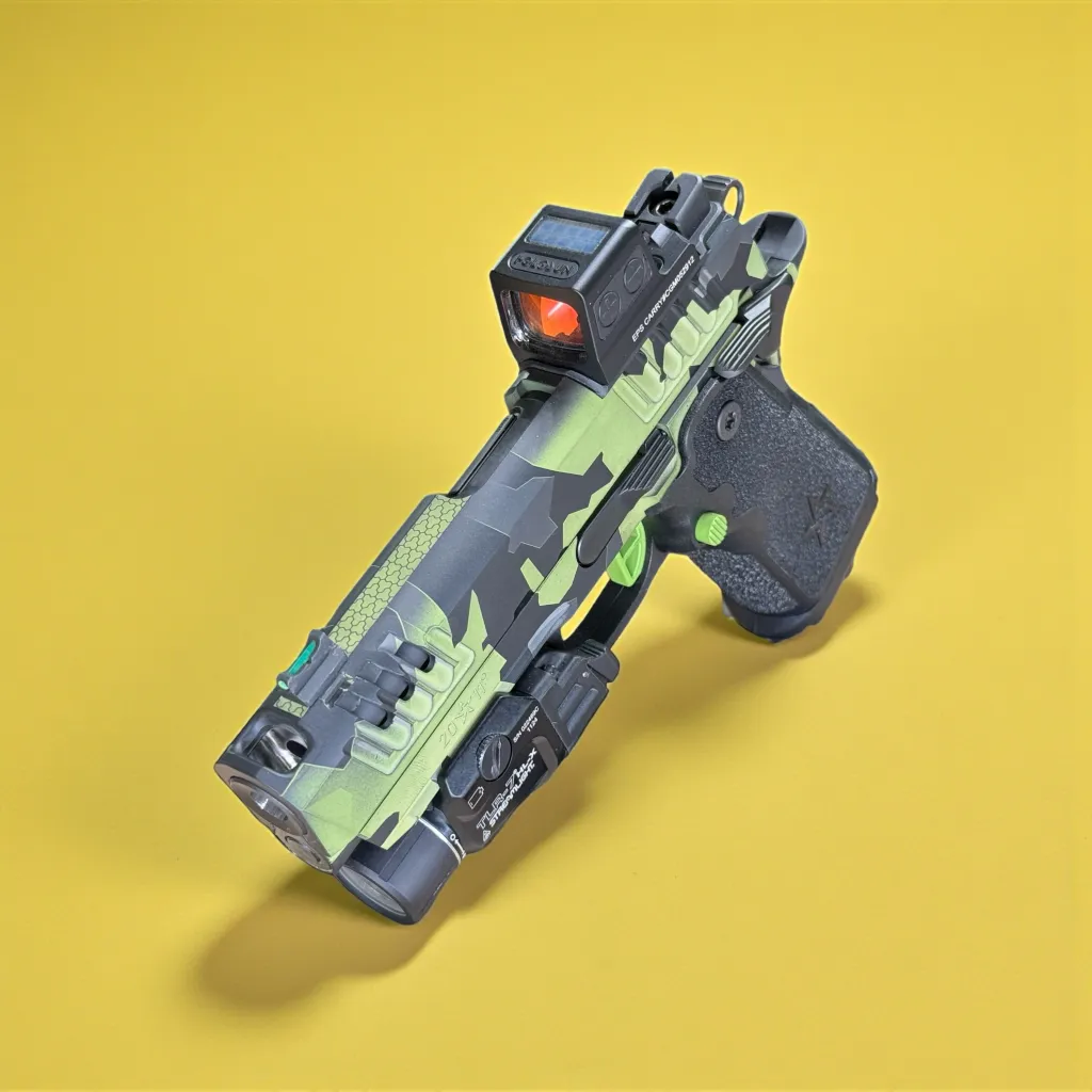 Green and grey custom pistol against a yellow backdrop
